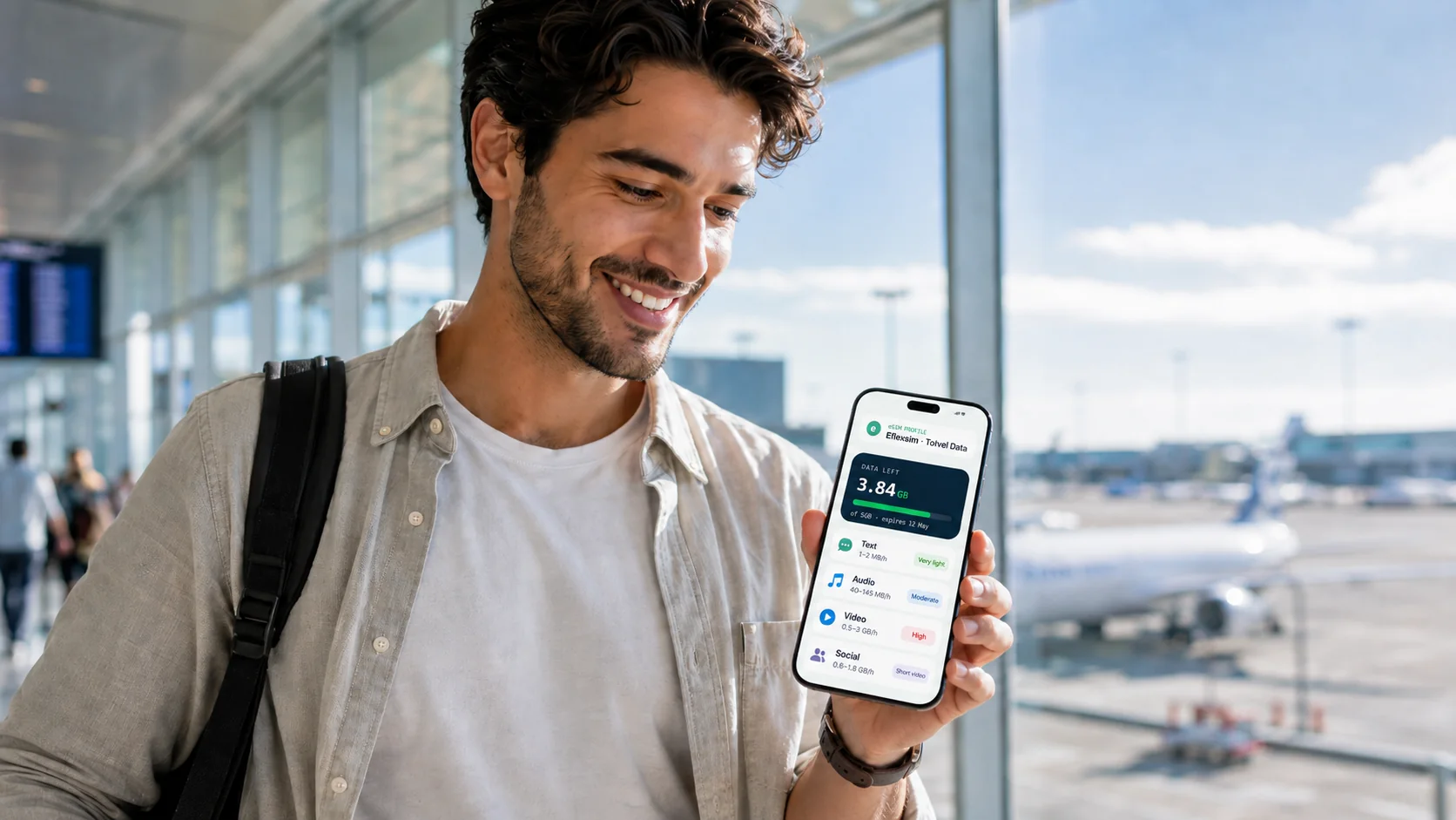 A traveler checking their phone at an airport, deciding how much data they need.